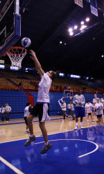 A Special Olympian puts the ball in the net at one of the clinic's dunking stations